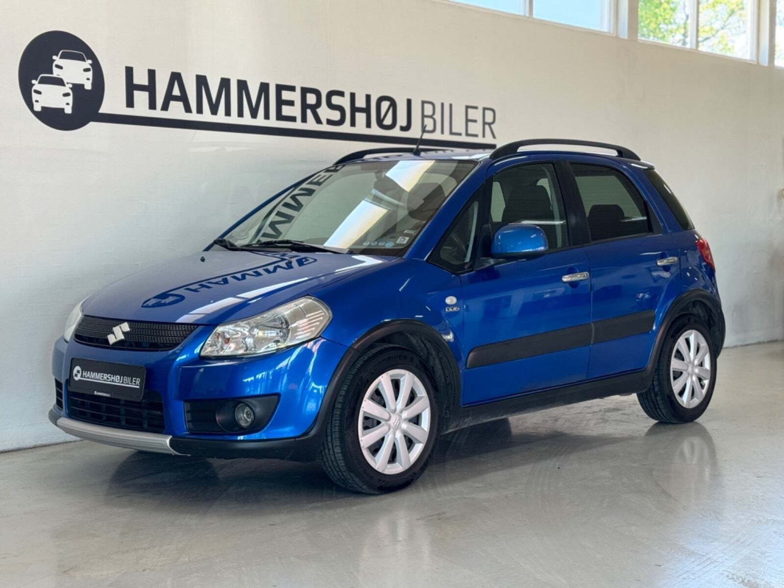 Blå Suzuki SX4 fra 2009