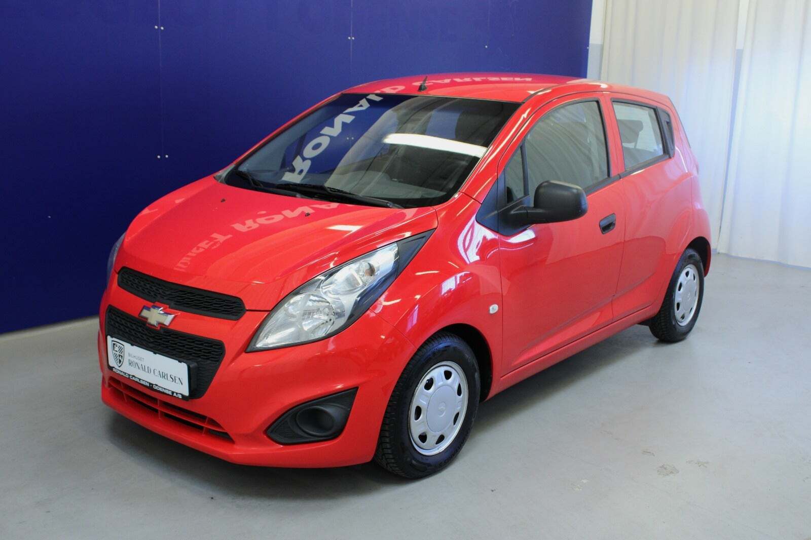 Rød Chevrolet Spark fra 2013