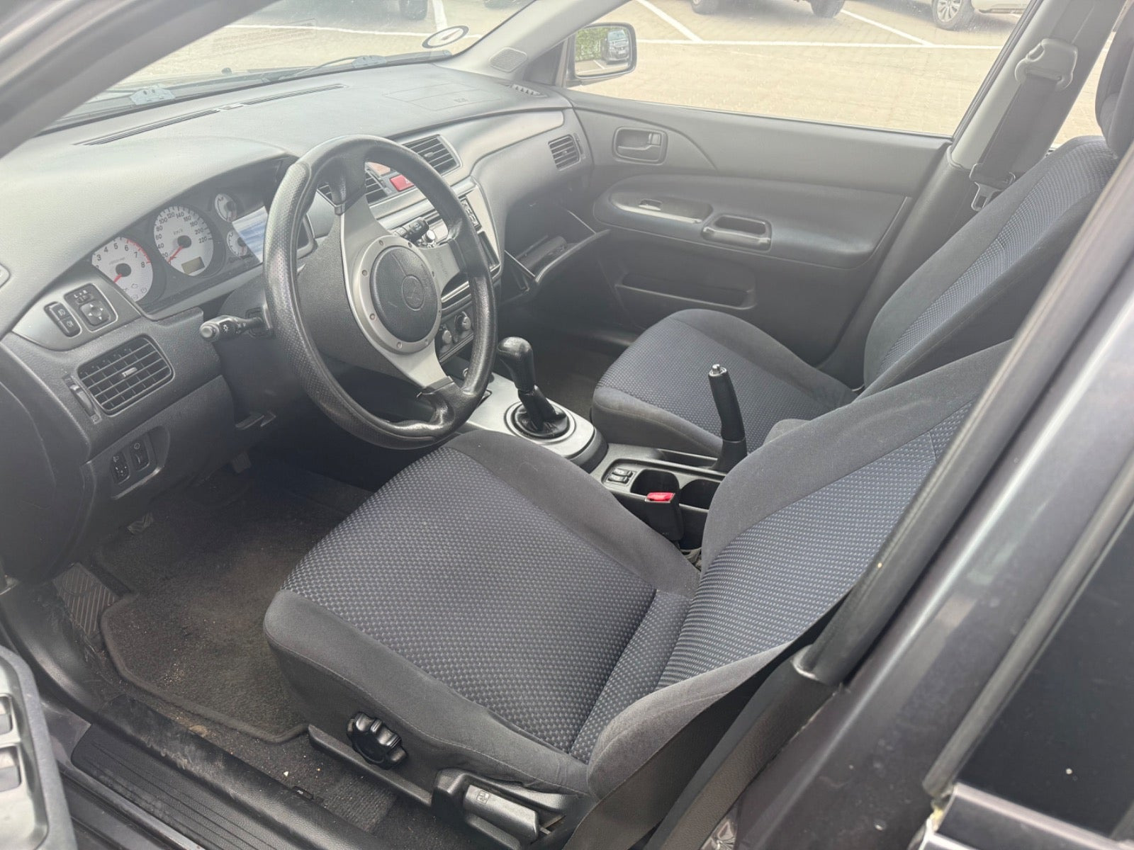 Grå Mitsubishi Lancer fra 2007 set indefra