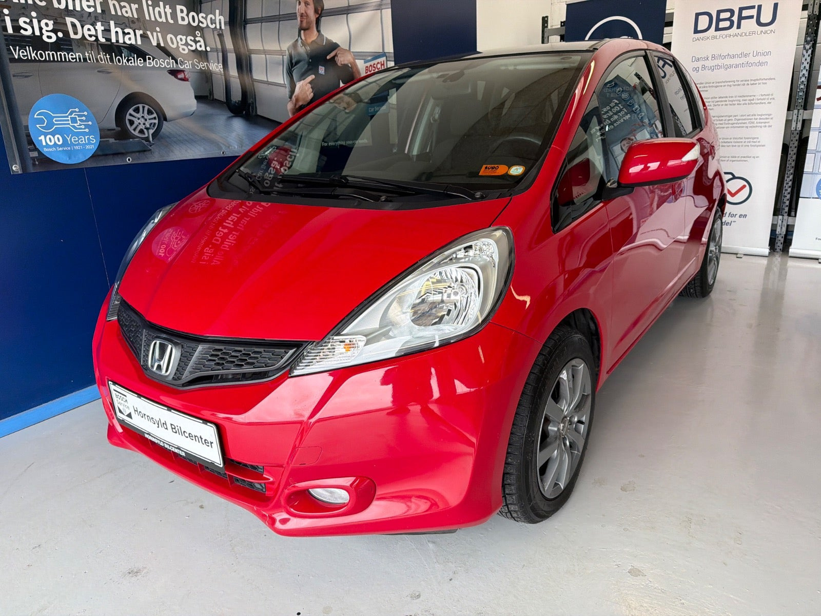 Rød Honda Jazz fra 2011