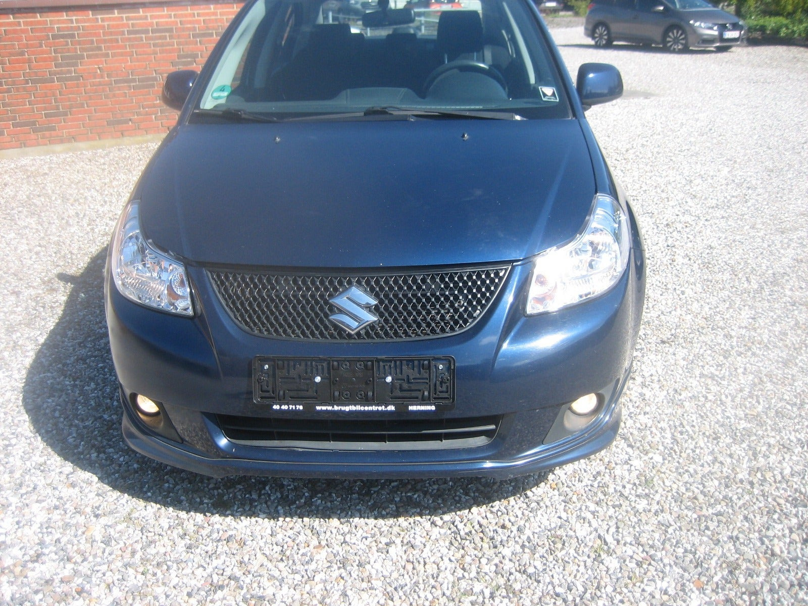 Blå Suzuki SX4 fra 2011