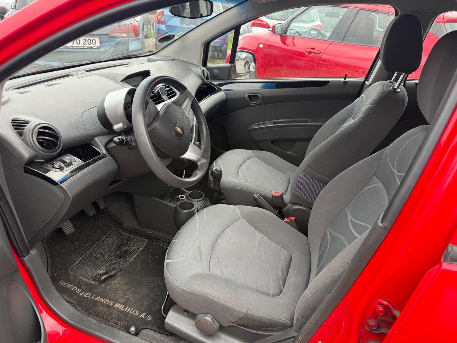 Rød Chevrolet Spark fra 2011